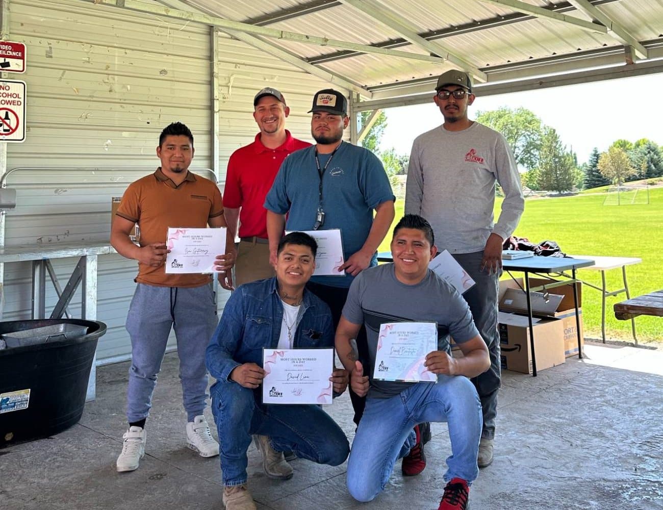 Goff Welding crew members holding company awards
